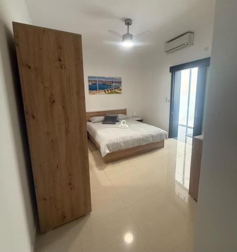 a bedroom with a bed and a wooden door at Traveller's Rest Gudja in Gudja