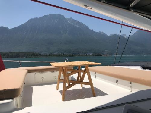 a wooden table on the deck of a boat at Floatinn Boat-BnB in Geneva