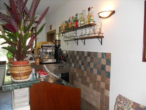 a kitchen with a sink and a counter with drinks at Agriturismo La Selva in Nocera Umbra