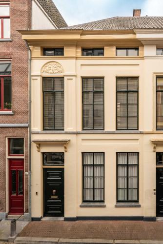 an apartment building with red doors and windows at Zocher6 a monumental town house in the city center in Utrecht