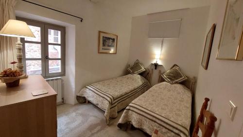 a room with two beds and a desk and a window at Roussillon House in Roussillon