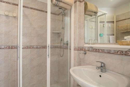 a bathroom with a shower and a sink at Hotel Olimpia in Sirmione