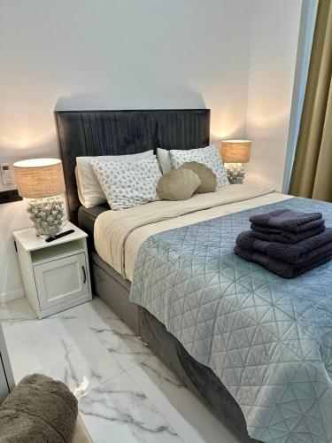 a bedroom with a large bed with two lamps on it at Mark Suite B8 in Fuengirola