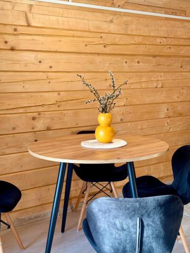 a table with a yellow vase on top of it at Водограй in Vorokhta