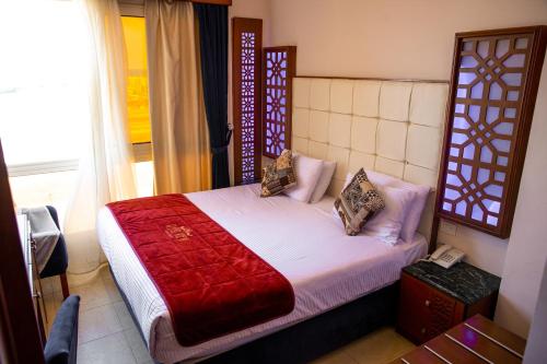 a bedroom with a bed and a phone in a room at Retal View North Coast Aqua Park in El Alamein