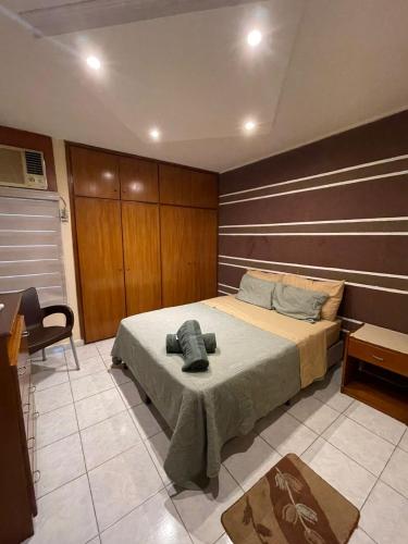 a bedroom with a bed with a wooden wall at Apartamento Maracay Base Aragua in Maracay