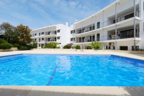 a large swimming pool in front of a building at Apartment Perola-superb Base In Historical Centre in Tavira