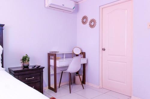 a bedroom with a desk and a chair next to a bed at Tranquility Villa in Priory