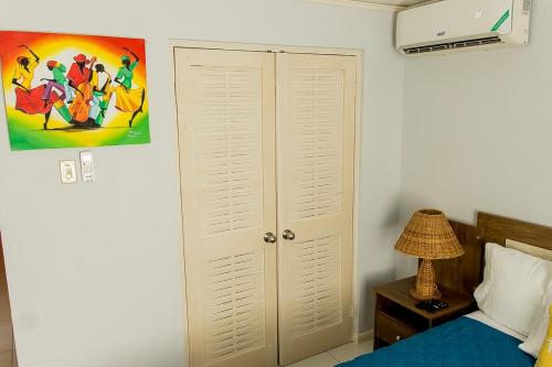 a bedroom with a bed and a white closet at Tranquility Villa in Priory