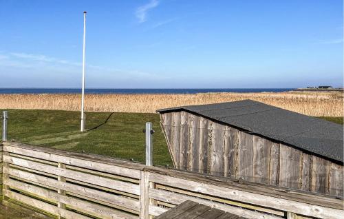 a wooden fence with a black roof on the beach at 2 Bedroom Stunning Home In Vinderup in Vinderup