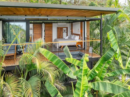 a bedroom in a house in the jungle at The Green House, Santa Teresa - Adults Only in Santa Teresa Beach