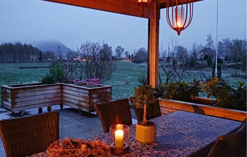 a patio with a table with candles and a bench at Nice Home In Stårheim With Wifi in Stårheim