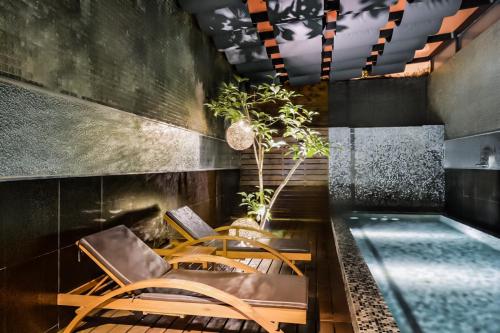 a dining room with a table and chairs and a pool at Xiadu Motel in Taichung