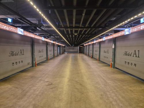 an empty hallway in a parking garage with lights at Pohang A1 Hotel Yeongildae Branch in Pohang