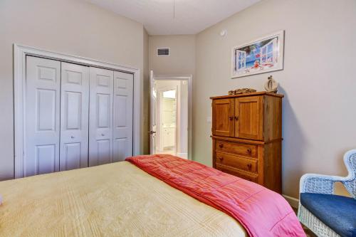 a bedroom with a bed and a wooden dresser at 1 block from the beach next to Ft Clinch State Park and 2 miles from Historic Centre Street in Fernandina Beach