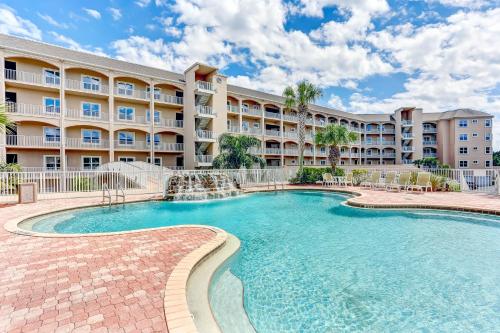 a pool in front of a large apartment building at 1 block from the beach next to Ft Clinch State Park and 2 miles from Historic Centre Street in Fernandina Beach