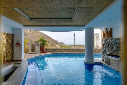 a large swimming pool with a view of a mountain at Terrazas Rodadero Santa Marta in Santa Marta