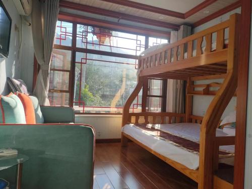 a bedroom with two bunk beds and a window at Tianjin Jixian Libo Family Farmstay in Jizhou