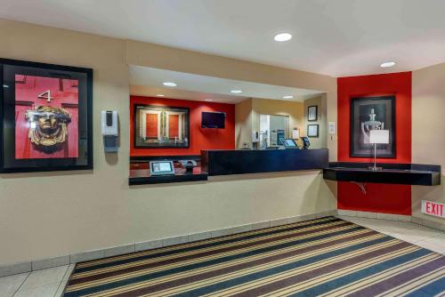 a lobby of a hotel with red walls at Extended Stay America Suites - Sacramento - West Sacramento in West Sacramento