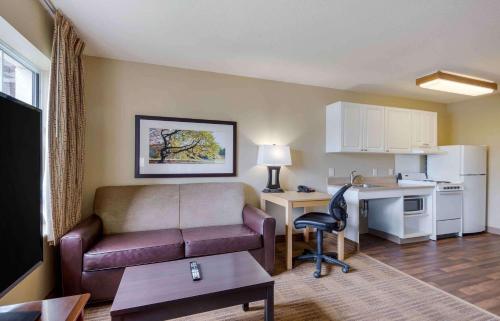a living room with a couch and a desk at Extended Stay America Suites - Greensboro - Airport in Greensboro