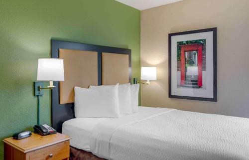 a hotel room with a large bed and two lamps at Extended Stay America Suites - Atlanta - Marietta - Powers Ferry Rd in Atlanta