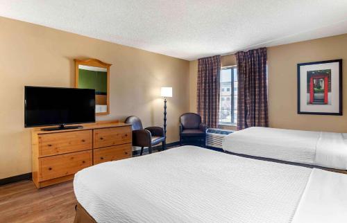 a hotel room with two beds and a flat screen tv at Extended Stay America Suites - Los Angeles - Monrovia in Monrovia