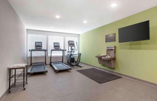 a gym with three exercise bikes and a flat screen tv at Extended Stay America Suites - Tampa - Casino Area in Tampa