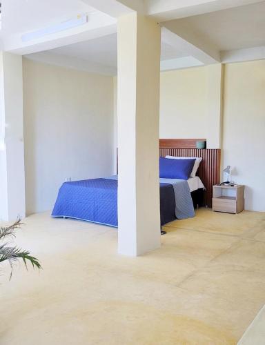 a bedroom with two beds and a pillar at Studio apartment in the mountains in Santa Marta