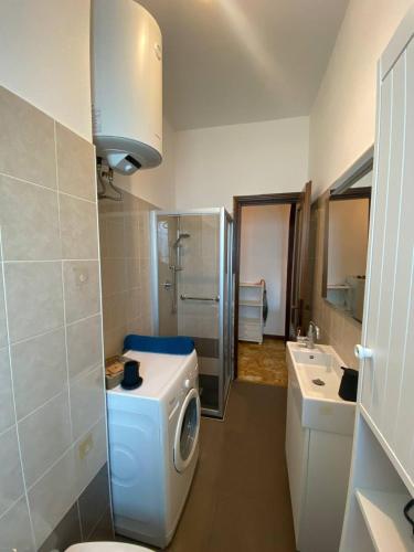 a bathroom with a washing machine and a sink at Villa Ferrari - Park Monza F1 Circuit in Villasanta