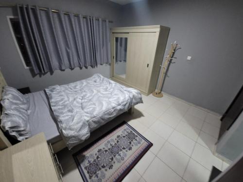 a hospital room with a bed and a mirror at Seaside 1BR Perfect Getaway in Ajman 