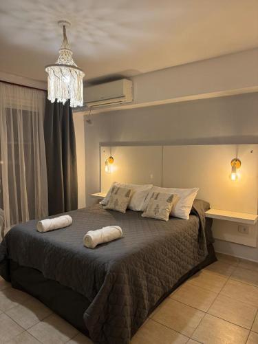 a bedroom with a large bed with two pillows on it at Depto. PREMIUM Barrio Norte in San Miguel de Tucumán
