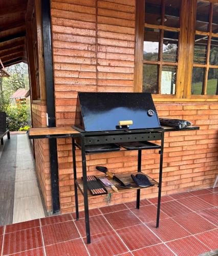 a grill sitting on a table on a patio at Cabaña San Isidro in Choachí