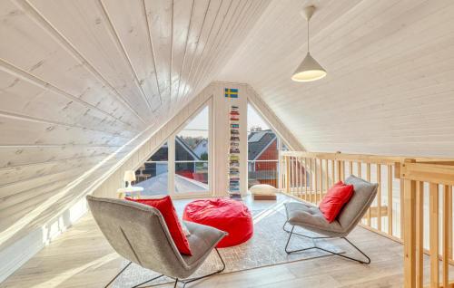 a living room with two chairs and red pillows at Stunning Home In Zerpenschleuse in Berg