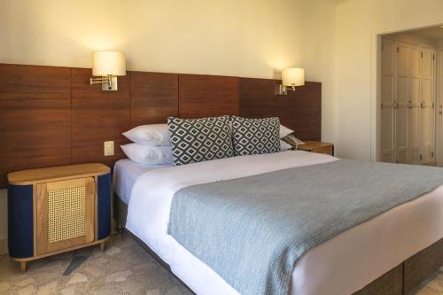 a bedroom with a large bed with pillows on it at Hotel Caribe by Faranda Grand, a member of Radisson Individuals in Cartagena de Indias