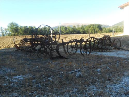 a group of wooden implements sitting in a field at Agriturismo La Selva in Nocera Umbra