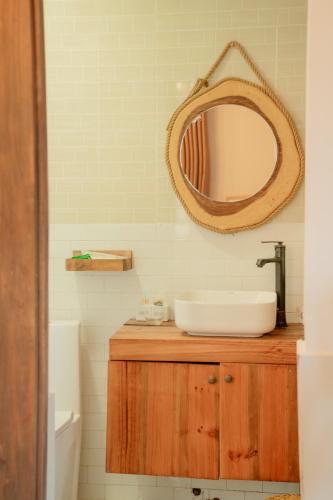 a bathroom with a sink and a mirror on a counter at Hoang Yen Villa & Coffee in Da Lat