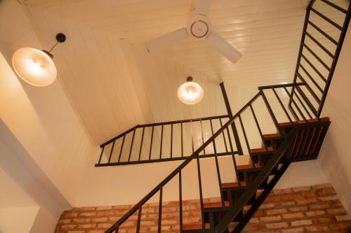 a staircase with two lights and a ceiling at Hoang Yen Villa & Coffee in Da Lat