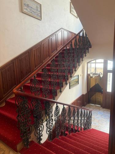 a staircase with a red carpet and a red stair case at Hotel Liliova Prague Old Town in Prague