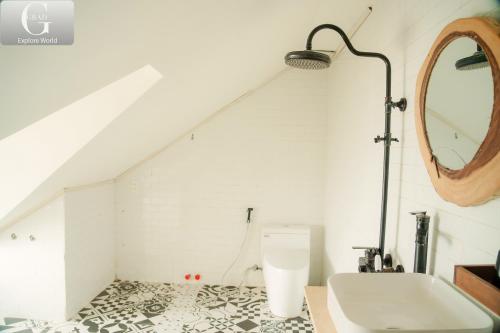 a bathroom with a bath tub and a mirror at Hoang Yen Villa & Coffee in Da Lat