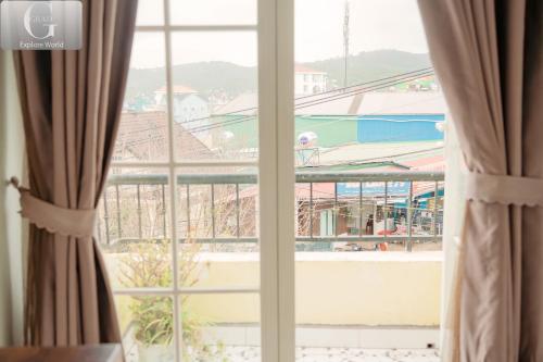 a window with a view of a city at Hoang Yen Villa & Coffee in Da Lat