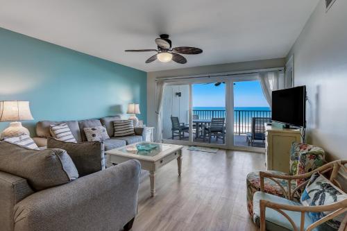 a living room with a couch and chairs and a television at Kid Friendly Condo with Stunning View of the Atlantic in Fernandina Beach
