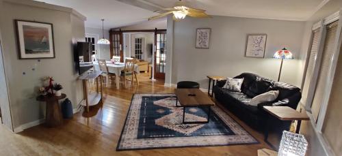 a living room with a couch and a dining room at Ranch with Cactuses in Millsboro