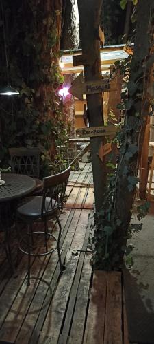 a wooden floor with a chair and a tree at Mindfulness Glamping, Retiro de Yoga, Todo Incluido in Mexico City