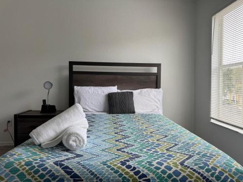 une chambre avec un lit avec une couette dessus dans l'établissement 2222-3-SV-Charming condo, à Kissimmee