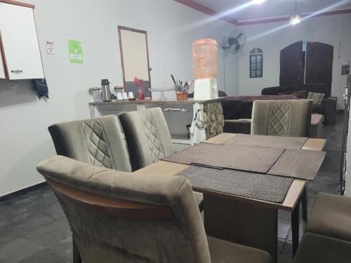 a dining room with a table and chairs at Unidades 1 e 2 e 3 Pousada do Sossego Mar e Verde in Itanhaém