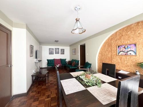 a dining room and living room with a table and chairs at Departamento acogedor en la mejor zona de La Paz in La Paz