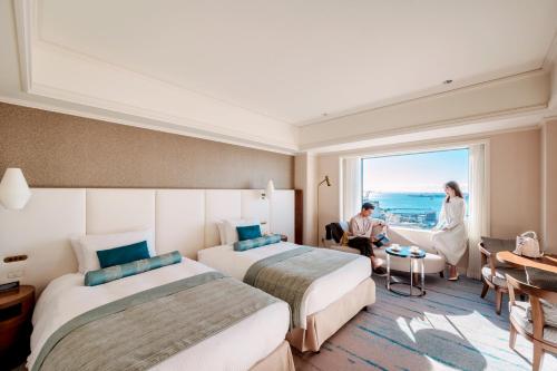 a hotel room with two beds and a window at Grand Nikko Tokyo Daiba in Tokyo