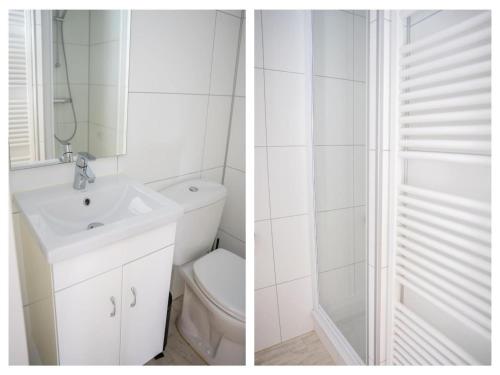 a white bathroom with a sink and a toilet at Pets Welcome, Veluwe Farmhouses for All in Ermelo