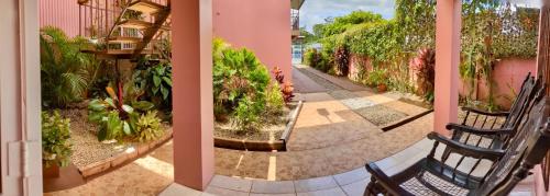 a walkway in a building with chairs and plants at Departamento Ángeles del Arenal #1 in Fortuna