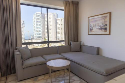 a living room with a couch and a large window at Hotel Caribe by Faranda Grand, a member of Radisson Individuals in Cartagena de Indias